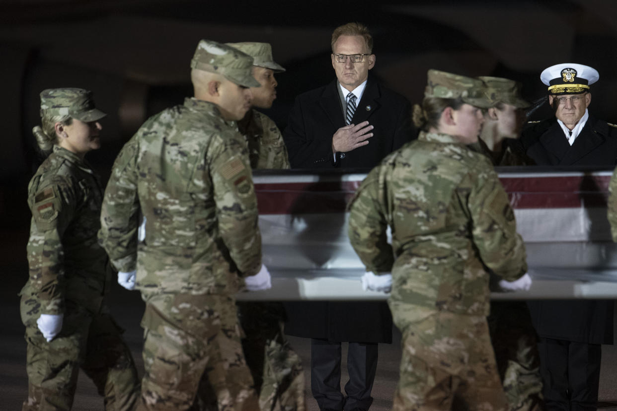 Acting Navy Secretary Thomas Modly, center, and Navy Adm. Michael Gilday, Chief of Naval Operations, look on as an Air Force carry team moves a transfer case containing the remains of Navy Ensign Joshua Kaleb Watson, Sunday, Dec. 8, 2019, at Dover Air Force Base, Del.. According to the Department of Defense, Watson was killed at the Naval Air Station mass shooting, Dec. 6, in Pensacola. (Photo: Cliff Owen/AP)