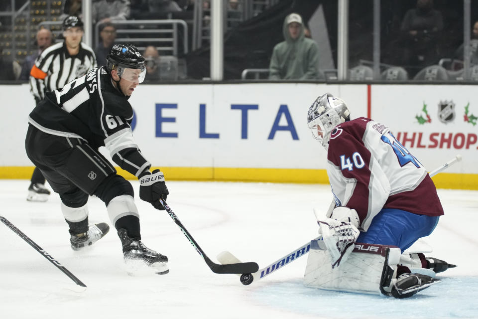 Colorado Avalanche goaltender Alexandar Georgiev (40) stops a shot by Los Angeles Kings center Trevor Lewis (61) during the second period of an NHL hockey game Sunday, Dec. 3, 2023, in Los Angeles. (AP Photo/Ashley Landis)