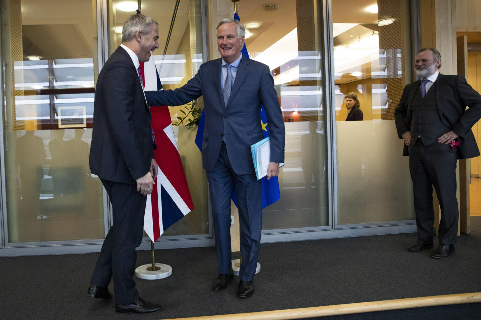 UK Brexit secretary Stephen Barclay, left, is welcomed by European Union chief Brexit negotiator Michel Barnier next to British Ambassador to the EU Tim Barrow, right, before their meeting at the European Commission headquarters in Brussels, Friday, Oct. 11, 2019. (AP Photo/Francisco Seco, Pool)