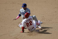 Los Angeles Angels' David Fletcher (22) steals second as the ball get by Los Angeles Dodgers second baseman Gavin Lux during the eight inning of a baseball game in Anaheim, Calif., Sunday, May 9, 2021. Fletcher went on to third. (AP Photo/Alex Gallardo)