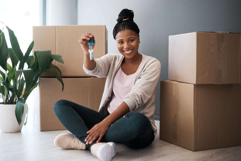 Woman holding the keys to a new house