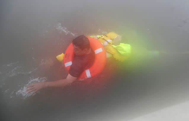 Wilford Martinez (left) is rescued from his flooded car along Interstate 610 in floodwaters from Tropical Storm Harvey. Source: AP