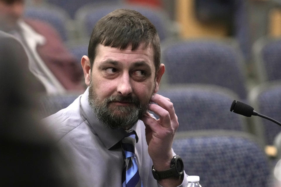 Sean Hodgson, a member of the U.S. Army Reserve, shows where he was punched by Robert Card while giving testimony, Thursday, April 25, 2024, in Augusta, Maine, during a hearing of the independent commission investigating the law enforcement response to the mass shooting in Lewiston, Maine. (AP Photo/Robert F. Bukaty)