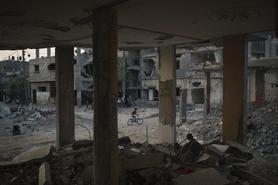 A boy rides his bike along Al-Baali Street, next to houses heavily damaged by airstrikes during the recent 11-day war in Beit Hanoun, northern Gaza Strip, Sunday, June 13, 2021. Six years ago, U.N. officials warned that wars and economic isolation had done so much to intensify Gaza’s “de-development” that it risked becoming uninhabitable by 2020. Since then, the Strip’s 2 million residents have endured yet another war, even as the economy teeters, with unemployment close to 50 percent, among the world’s highest. (AP Photo/Felipe Dana)