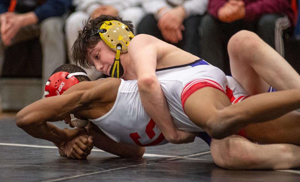 Hononegah's Rocco Cassioppi, top, wrestles Jamiel Castleberr to win the 106-pound championship match during the Dvorak Invitational Wrestling Tournament on Sunday, Dec. 16 2023, at Harlem High School in Loves Park.