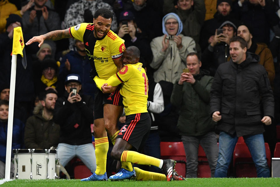 Watford's English striker Troy Deeney (L) celebrates with Watford's French midfielder Abdoulaye Doucoure after scoring his team's third goal during the English Premier League football match between Watford and Liverpool at Vicarage Road Stadium in Watford, north of London on February 29, 2020. (Photo by Justin TALLIS / AFP) / RESTRICTED TO EDITORIAL USE. No use with unauthorized audio, video, data, fixture lists, club/league logos or 'live' services. Online in-match use limited to 120 images. An additional 40 images may be used in extra time. No video emulation. Social media in-match use limited to 120 images. An additional 40 images may be used in extra time. No use in betting publications, games or single club/league/player publications. /  (Photo by JUSTIN TALLIS/AFP via Getty Images)