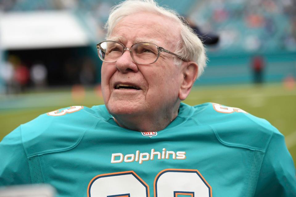 <p>Ron Elkman/Sports Imagery/Getty</p> Warren Buffett in a Miami Dolphins jersey