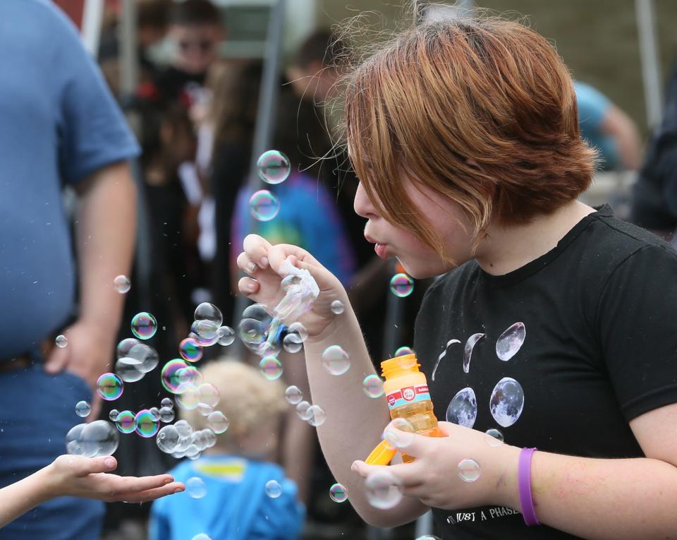 Nolley Elementary student Jade Nall blows bubbles during a party to celebrate the schools designation as a Hall of Fame school and say goodbye to the old building in New Franklin.