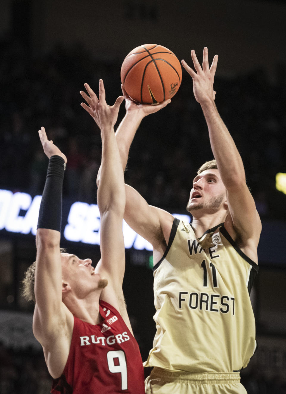 Wake Forest forward Andrew Carr (11) shoots over Rutgers' forward Oskar Palmquist (9) during the first half of an NCAA college basketball game on Wednesday, Dec. 6, 2023, at Joel Coliseum in Winston-Salem, N.C. (Allison Lee Isley/The Winston-Salem Journal via AP)