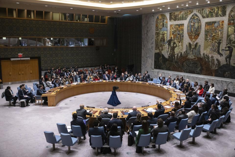 Representatives of member countries take vote during the Security Council meeting at United Nations headquarters, Friday, Dec. 22, 2023. After many delays, the U.N. Security Council adopted a watered-down resolution Friday calling for immediately speeding up aid deliveries to desperate civilians in Gaza but without the original call for an “urgent suspension of hostilities” between Israel and Hamas. (AP Photo/Yuki Iwamura)