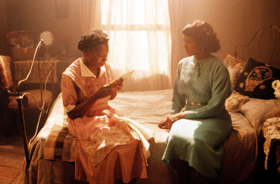 Celie and Shug sit on the bed together