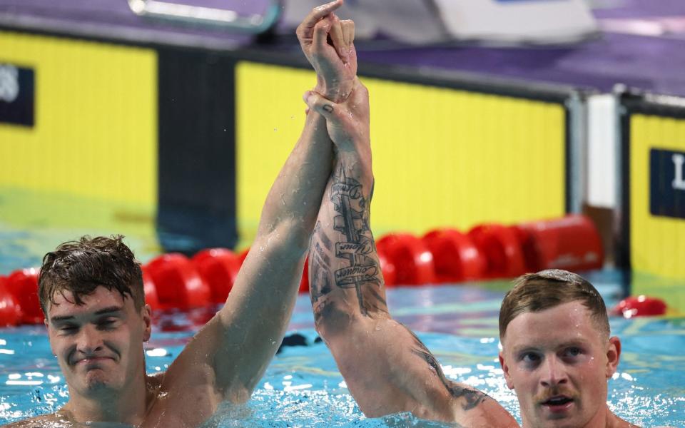 Peaty raises Wilby hand after the shock result  - REUTERS