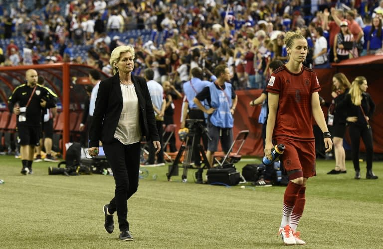 Germany's head coach Silvia Neid (L) and Germany's midfielder Simone Laudehr leave a field at the Olympic Stadium in Montreal on June 30, 2015