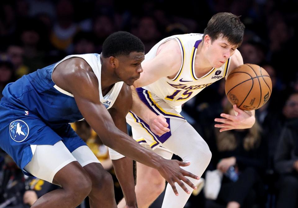 Lakers guard Austin Reaves, right, steals the ball from Minnesota's Anthony Edwards during the third quarter Sunday.