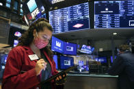 In this photo provided by the New York Stock Exchange, trader Ashley Lara uses her handheld device as she works on the trading floor, Tuesday, Dec. 1, 2020. U.S. stocks rose broadly in morning trading Tuesday, sending the S&P 500 toward another record high, as investors focus on the possibility that coronavirus vaccines could soon help usher in a fuller global economic recovery. (Colin Ziemer/New York Stock Exchange via AP)