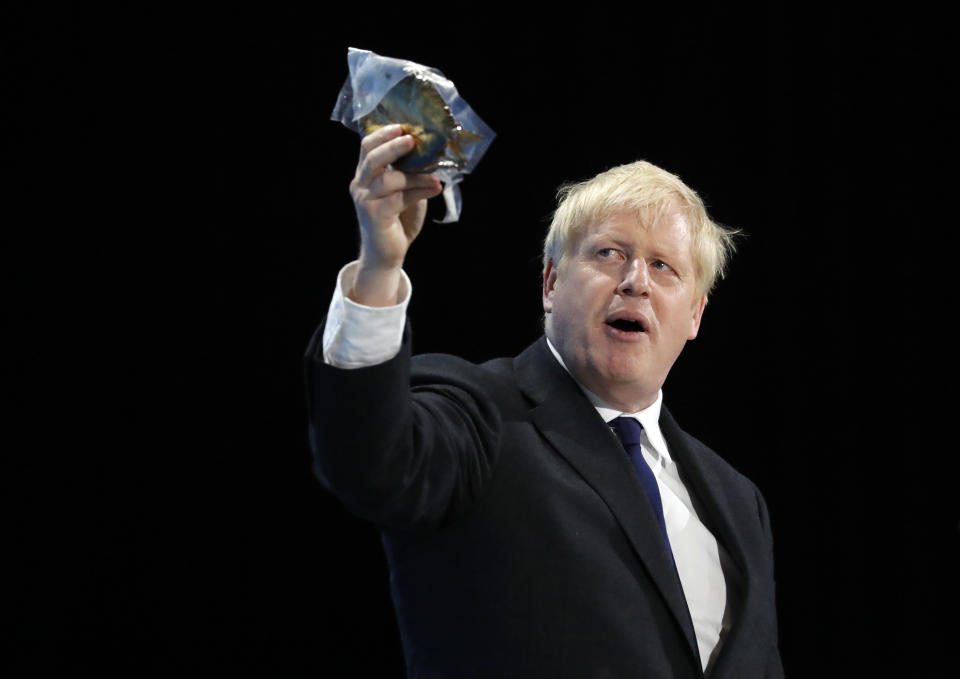 Conservative party leadership candidate Boris Johnson holds up a Jewish kippah during his speech during a Conservative leadership hustings at ExCel Centre in London, Wednesday, July 17, 2019. The two contenders, Jeremy Hunt and Boris Johnson are competing for votes from party members, with the winner replacing Prime Minister Theresa May as party leader and Prime Minister of Britain's ruling Conservative Party. (AP Photo/Frank Augstein)