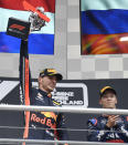 Red Bull driver Max Verstappen of the Netherland's, left, celebrates on the podium after he won the German Formula One Grand Prix at the Hockenheimring racetrack in Hockenheim, Germany, Sunday, July 28, 2019. On the right is third place Toro Rosso driver Daniil Kvyat of Russia. (AP Photo/Jens Meyer)