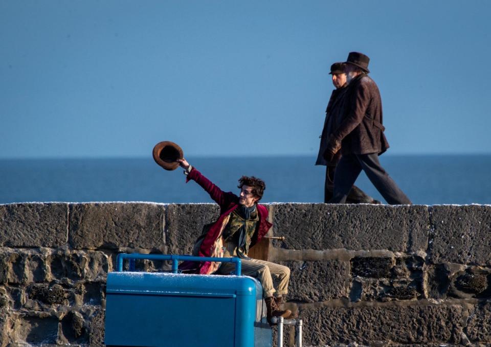 LYME REGIS, ENGLAND - OCTOBER 12: Timothée Chalamet is seen as Willy Wonka leaving the ship on the top of a van during filming for the Warner Bros and the Roald Dahl Story Company's upcoming movie 'Wonka' on October 12, 2021, in Lyme Regis, England. This film will focus on the young Willy Wonka on his earliest adventure and how he met the Oompa-Loompas. (Photo by Finnbarr Webster/Getty Images)