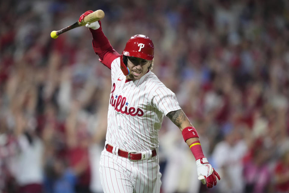 Philadelphia Phillies' Bryson Stott reacts after hitting a grand slam against Miami Marlins pitcher Andrew Nardi during the sixth inning of Game 2 in an NL wild-card baseball playoff series, Wednesday, Oct. 4, 2023, in Philadelphia. (AP Photo/Matt Slocum)