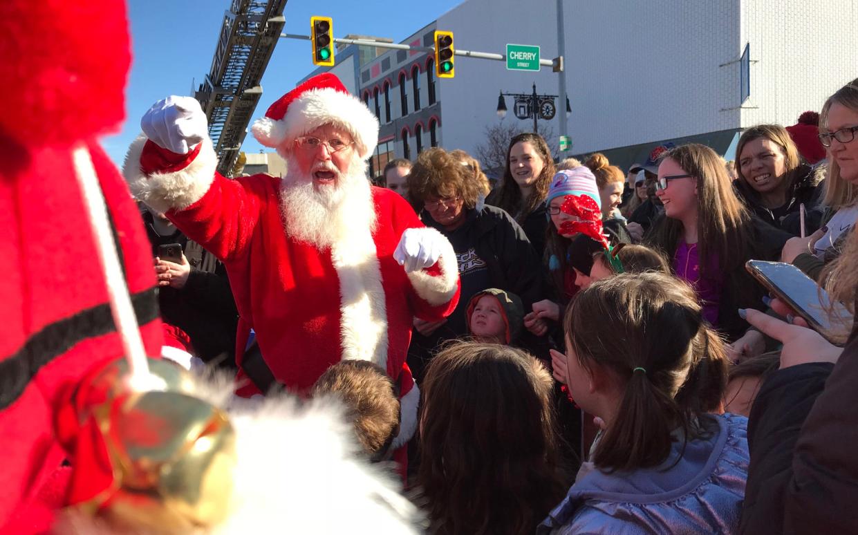 Santa greets the crowd after being rescued from the First Mid Bank & Trust rooftop by Galesburg Firefighters before the 2019 Holidays Parade. The rescue is planned for 4:30 p.m. Sunday at the corner of Main and Cherry streets in Galesburg.