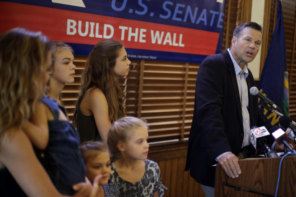 Flanked by family members, former Kansas Secretary of State Kris Kobach addresses the crowd as he announces his candidacy for the Republican nomination for the U.S. Senate Monday, July 8, 2019, in Leavenworth, Kan. (AP Photo/Charlie Riedel)