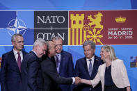 FILE - Turkish Foreign Minister Mevlut Cavusoglu, third left, shakes hands with Sweden's Prime Minister Magdalena Andersson, right, next to Turkish President Recep Tayyip Erdogan, center, and Finland's President Sauli Niinisto, second right, after signing a memorandum in which Turkey agrees to Finland and Sweden's membership of the defense alliance in Madrid, Spain, Tuesday, June 28, 2022. It has not been an easy week for Russian President Vladimir Putin. He watched as NATO declared Moscow its main enemy and invited Russia's neighbors Sweden and Finland to join the alliance. (AP Photo/Bernat Armangue, File)