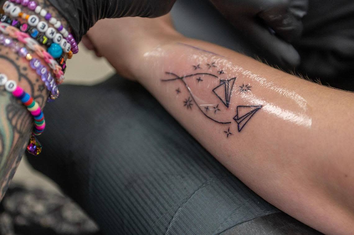 Ashley Hadaway, from Des Moines, Iowa, receives a Taylor Swift theme tattoo from the song “Out of the Woods” at The Cherry Bomb Tattoo Co. on Saturday, July 8, 2023, in Lee’s Summit. The tattoo shop is holding a Taylor Swift tattoo flash event starting from July sixth to the eighth.