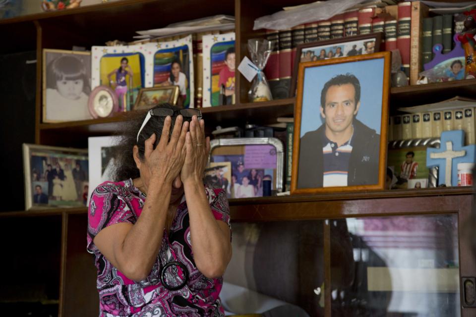 In this Feb. 5, 2014, photo, Maria Gonzalez, weeps next to a portrait of her son Cesar, during an interview with The Associated Press inside her home in Yautepec, Mexico. In 2012. Cesar, a 33-year-old architect and engineer, was kidnapped as he drove through Cuernavaca to visit his family in Yautepec. The family got together $10,000 and left it in packets of $2,000 in a cereal box in Cuernavaca. Five days later he was found dead in the trunk of his car. (AP Photo/Eduardo Verdugo)