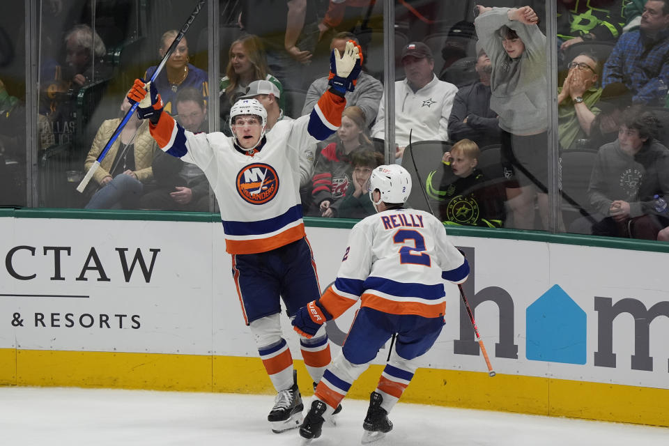 New York Islanders center Bo Horvat (14) celebrates after his overtime winning goal with teammate Mike Reilly (2) in an NHL hockey game against the Dallas Stars in Dallas, Monday, Feb. 26, 2024. (AP Photo/LM Otero)