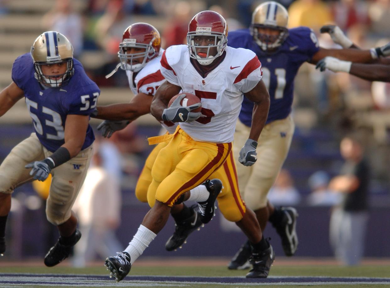 USC's Reggie Bush rushes the ball against Washington during the third quarter at Husky Stadium in Seattle on Oct. 22, 2005.
