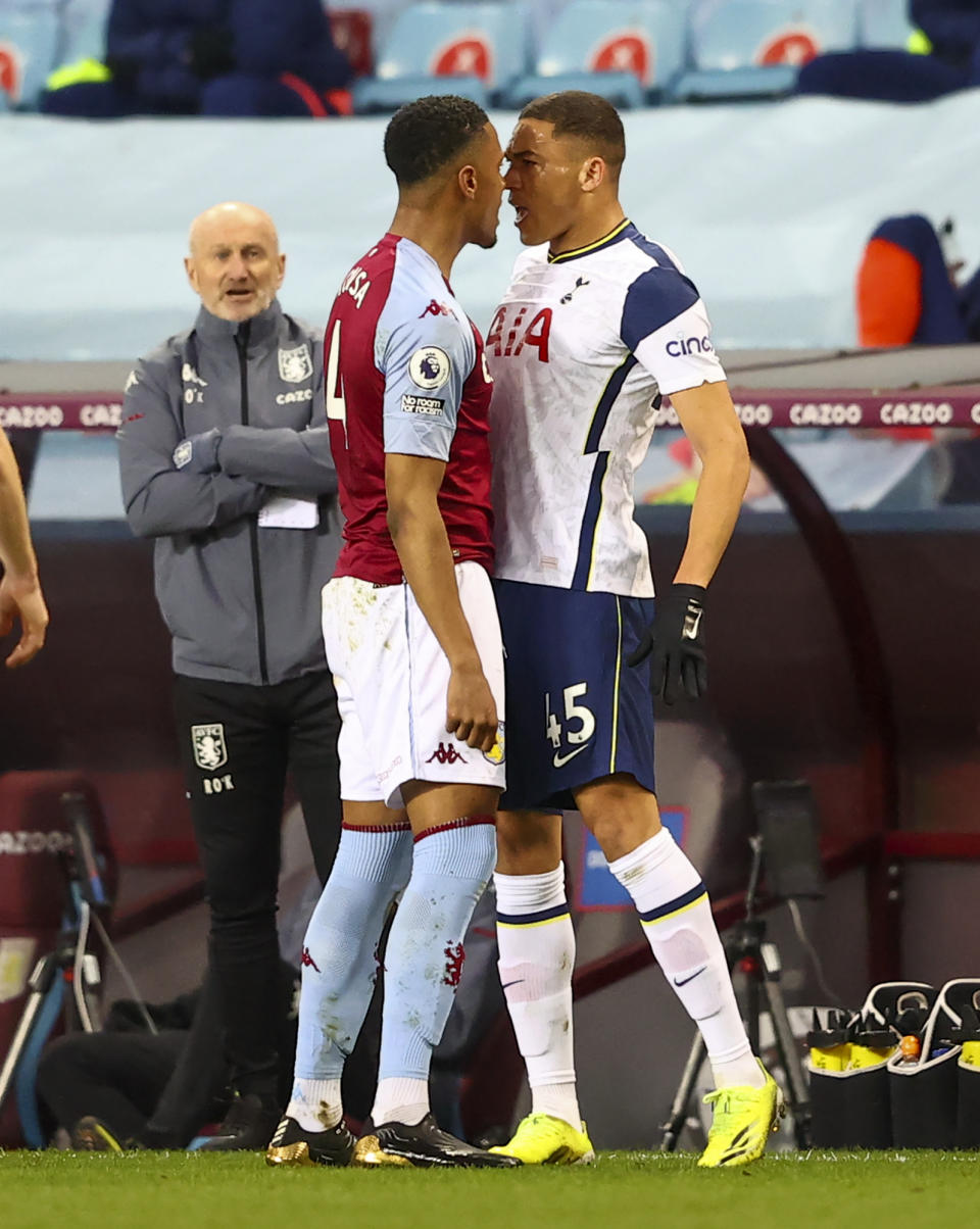 Aston Villa's Ezri Konsa, left, and Tottenham's Carlos Vinicius react during the English Premier League soccer match between Aston Villa and Tottenham Hotspur at Villa Park in Birmingham, England, Sunday, March 21, 2021. (AP Photo/Michael Steele,Pool)