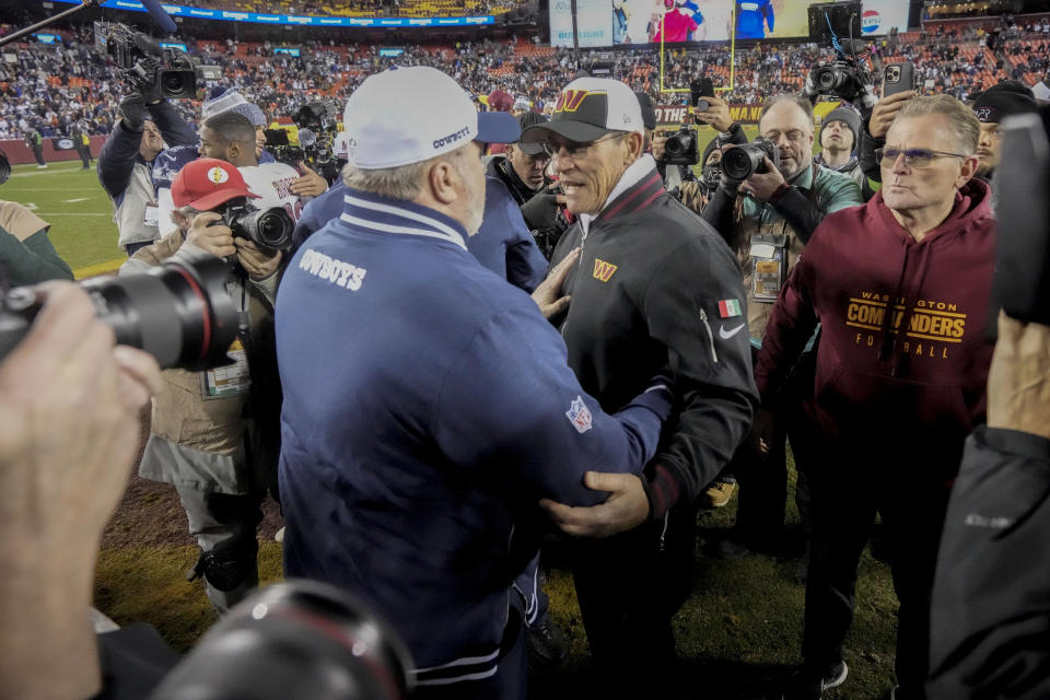 Dallas Cowboys head coach Mike McCarthy and Washington Commanders head coach Ron Rivera, right meeting on the field at the end of an NFL football game, Sunday, Jan. 7, 2024, in Landover, Md. Dallas won 38-10. (AP Photo/Mark Schiefelbein)