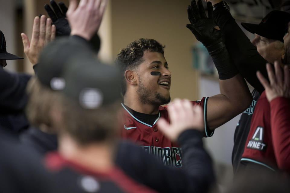 Arizona Diamondbacks' Gabriel Moreno celebrates with teammates in the dugout after hitting a home run during the second inning of a baseball game against the San Diego Padres,420 Thursday, June 6, 2024, in San Diego. (AP Photo/Gregory Bull)