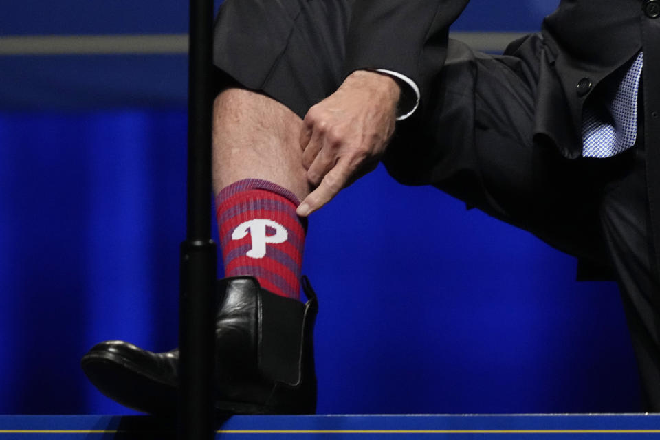 President Joe Biden shows off his Philadelphia Phillies socks as he speaks during the Pennsylvania Democratic Party's 3rd Annual Independence Dinner in Philadelphia, Friday, Oct. 28, 2022. (AP Photo/Matt Rourke)
