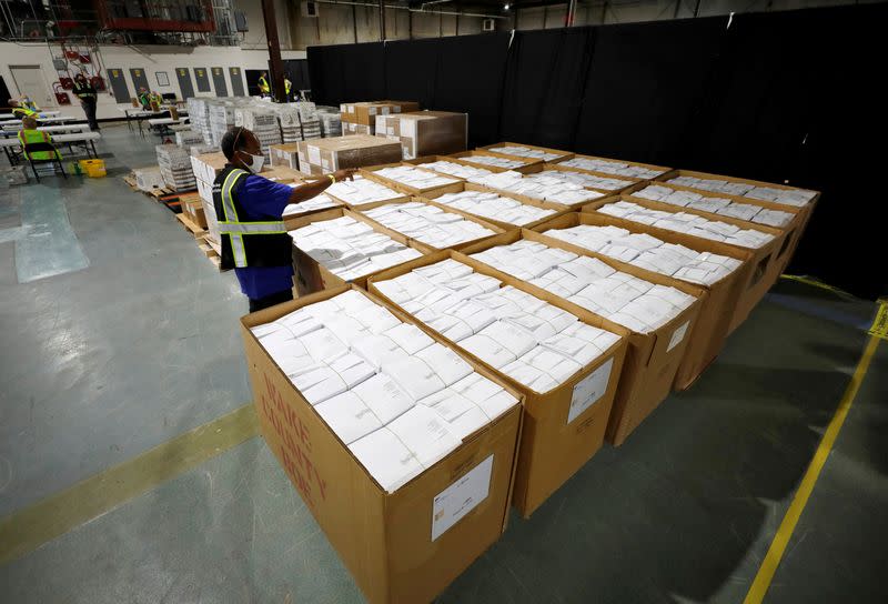 FILE PHOTO: Poll workers prepare absentee ballots for the general election in Raleigh