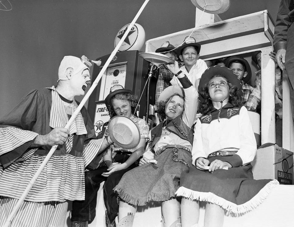 April 19, 1950: Clown R. R. Edwards, Jr. (in real life owner of an auto store), bobbed his flying saucers before delighted eyes of Sandra Lou Edwards, Linda Kay Smith, and Mary Sue Riley. A parade in Gainsville celebrating the town’s 100th birthday.