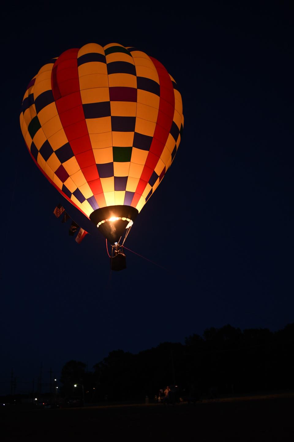 Hot air balloon pilot Bob Pulaski lights up the balloon as it floats up. Pulaski brought his balloon, the Ski Lift, and set up in the field next to Huckleberry Brewing Company Saturday night offering balloon rides for $10.