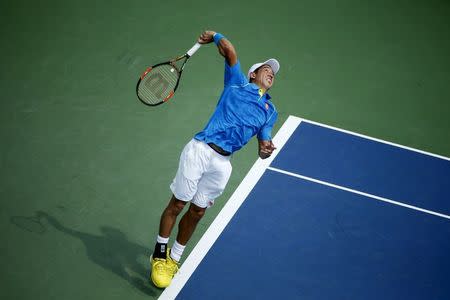 Kei Nishikori of Japan serves to Benoit Paire of France during their match at the U.S. Open Championships tennis tournament in New York, August 31, 2015. REUTERS/Mike Segar