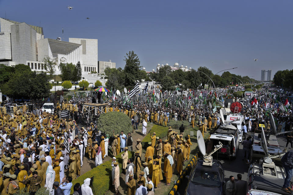 Supporters of Pakistan Democratic Movement, an alliance of the ruling political parties, attend a rally outside the Supreme Court, top left in Islamabad, Pakistan, Monday, May 15, 2023. Thousands of Pakistani government supporters converged on the country's Supreme Court, in a rare challenge to the nation's judiciary. Protesters demanded the resignation of the chief justice over ordering the release of former Prime Minister Imran Khan. (AP Photo/Anjum Naveed)