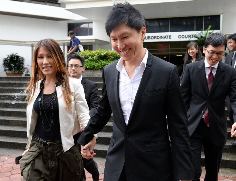 City Harvest Church founder Kong Hee and his pop-singer wife Ho Yeow Sun leave court in Singapore during his fraud trial on September 9, 2013