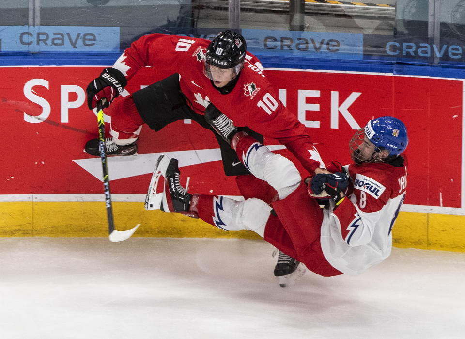 Canada's Dylan Holloway (10) checks Czech Republic's David Jiricek (8) during the second period of an IIHL World Junior Hockey Championship game, Saturday, Jan. 2, 2021 in Edmonton, Alberta. (Jason Franson/The Canadian Press via AP)