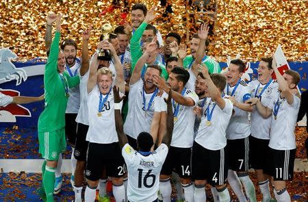 Soccer Football - Chile v Germany - FIFA Confederations Cup Russia 2017 - Final - Saint Petersburg Stadium, St. Petersburg, Russia - July 2, 2017 Germany’s Julian Brandt celebrates with the trophy and team mates after winning the FIFA Confederations Cup. REUTERS/Maxim Shemetov