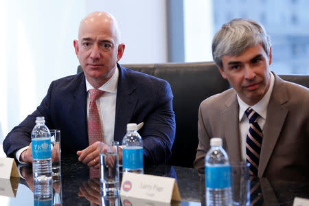 (L-R) Amazon CEO Jeff Bezos and Larry Page, CEO and Co-founder of Alphabet, sit during a meeting with U.S. President-elect Donald Trump and technology leaders at Trump Tower in New York, U.S., December 14, 2016. REUTERS/Shannon Stapleton