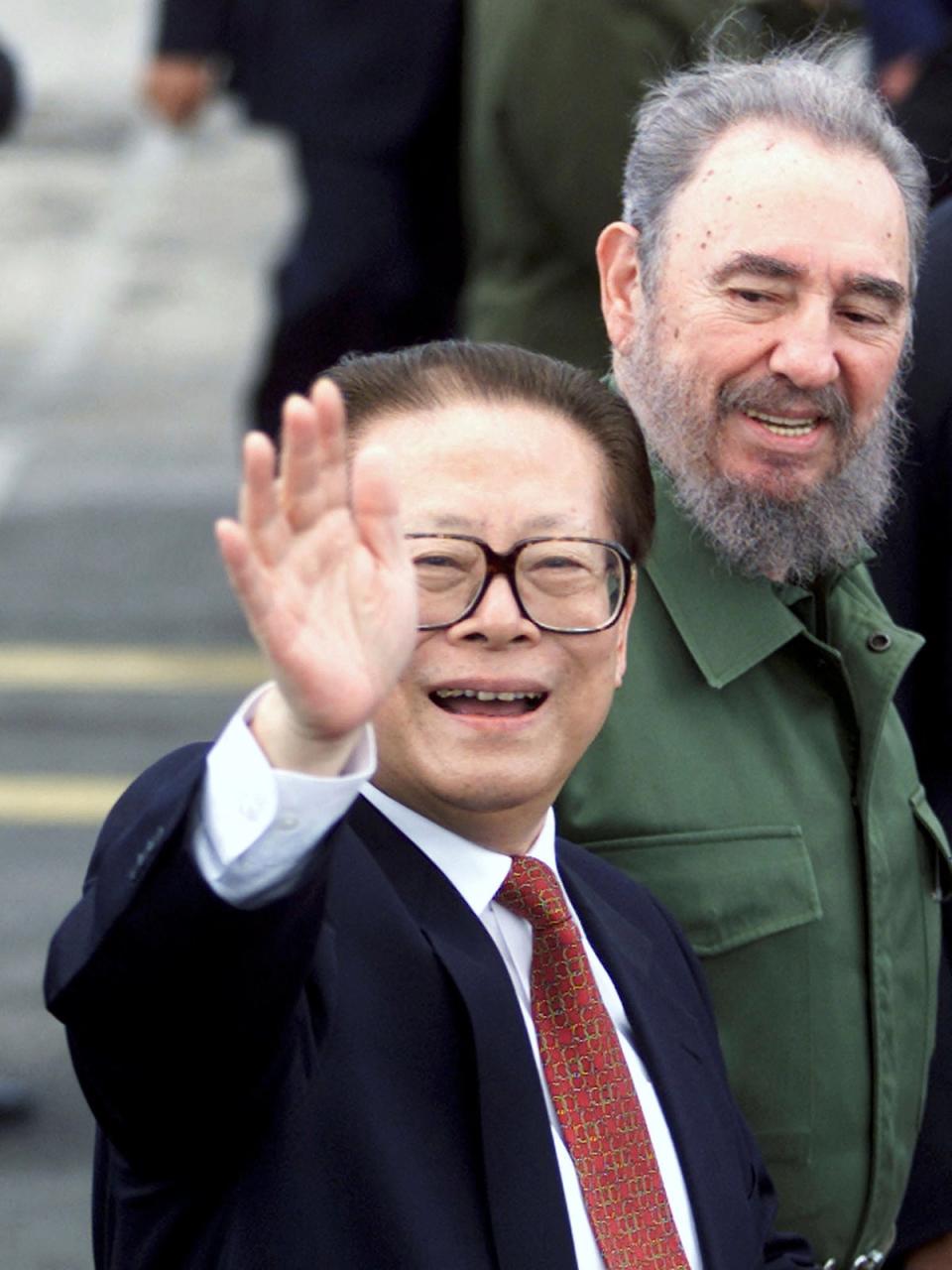 Jiang waves to the crowds after he was met by Cuba’s President Fidel Castro at Havana airport (Reuters)