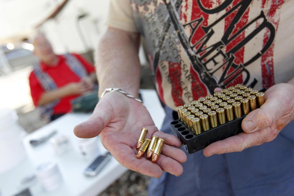 Doug Varrieur displays some .38 caliber ammunition on the firing range he set up in the yard of his home in Big Pine Key in the Florida Keys March 5, 2014. Varrieur, 57, discovered a little-noticed part of Florida law which prohibits local governments from restricting gun rights in any way, and in December he set up a personal gun range on his property in a residential subdivision. Neighbors were outraged by the live gunfire, but their surprise was nothing compared to that of municipal leaders, who were shocked to realize there was nothing they could do about it. Picture taken March 5, 2014. REUTERS/Andrew Innerarity (UNITED STATES - Tags: SOCIETY)