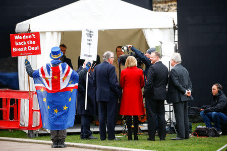 A pro-Brexit demonstrator stands behind a television crew outside the Houses of Parliament in London, Britain January 9, 2019. REUTERS/Henry Nicholls