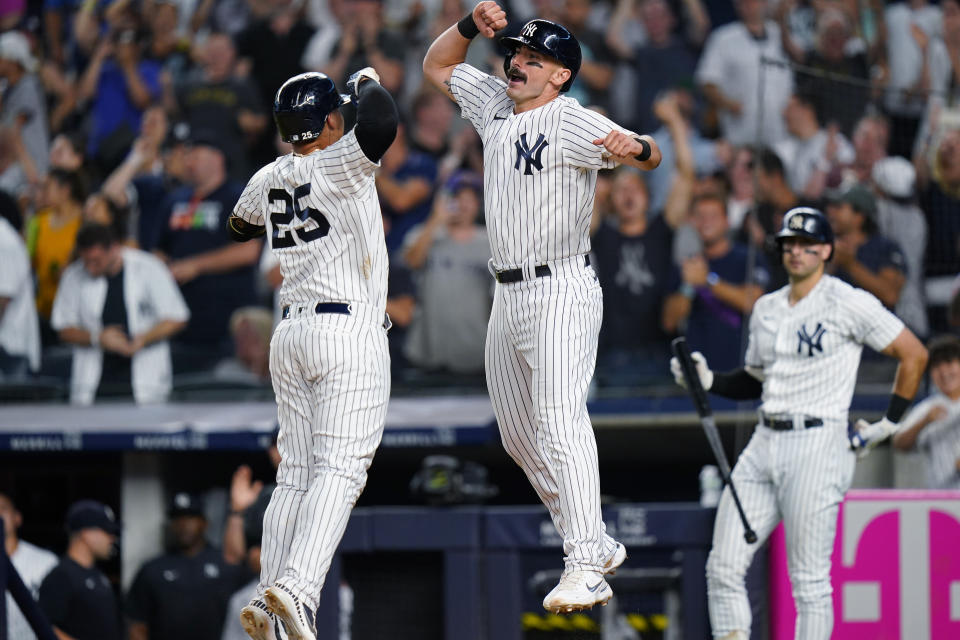 New York Yankees' Matt Carpenter, right, celebrates with Gleyber Torres after they scored against the Cincinnati Reds during the eighth inning of a baseball game Thursday, July 14, 2022, in New York. (AP Photo/Frank Franklin II)