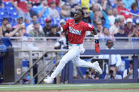 Miami Marlins' Jazz Chisholm Jr. heads home to score on a double by Jake Burger during the third inning of a baseball game against the Pittsburgh Pirates, Saturday, March 30, 2024, in Miami. (AP Photo/Wilfredo Lee)