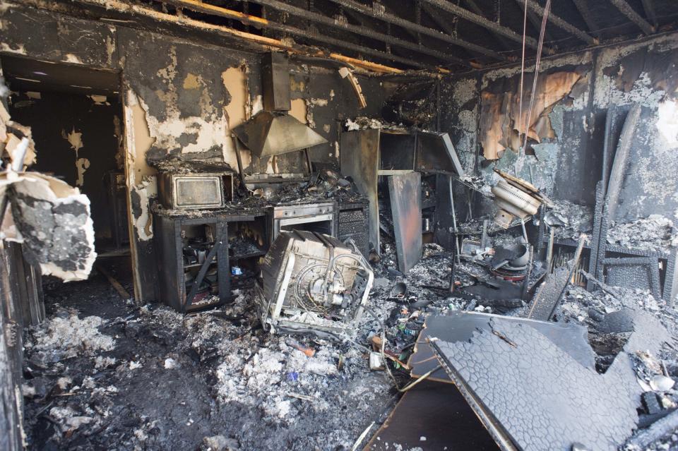 <p>The remnants of a home destroyed by Tuesday’s fire are seen in Moab, Utah, Wednesday, June 13, 2018. The blaze in Moab, known for its dramatic red rocks, started in a wooded area Tuesday night and quickly spread to homes over less than a square mile, Police Chief Jim Winder said. (Photo: Rick Egan/The Salt Lake Tribune via AP) </p>