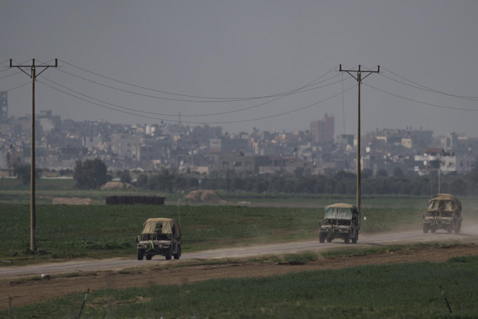 Israeli soldiers move near the Israeli-Gaza border as seen from southern Israel, Monday, Jan. 8, 2024. (AP Photo/Leo Correa)